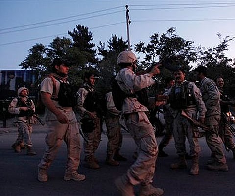 Afghan army officers greet each other after concluding a gun battle with militants in Kabul. (AP)
