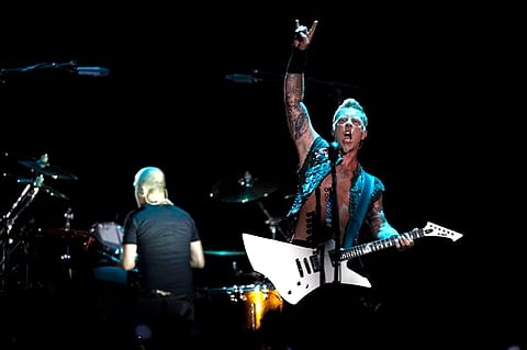 James Hetfield, lead singer for the heavy metal rock band "Metallica" performs during a concert at the Sports Palace, in Mexico City (AP Photo/Christian Palma).