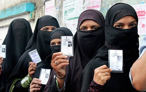 Muslim voters showing their voter identity cards before casting their vote for the Assembly elections at a polling station in Nagpur on Wednesday | PTI