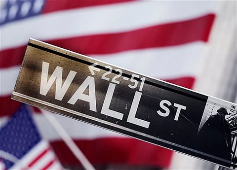 A file photo shows a Wall Street street sign near the New York Stock Exchange, in New York. U.S. AP