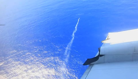 In this image made from TV, released by AMSA (Australia Maritime Safety Authority), a marker flare is deployed into the Indian Ocean from a Royal New Zealand Air Force (RNZAF) plane searching for debris from the missing Malaysian Airlines Flight 370, off 