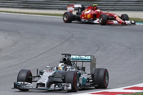 Mercedes driver Lewis Hamilton of Britain steers his car during the second training session at the race track in Spielberg,  Austria,  Friday, June 20, 2014. The Austrian Formula One Grand Prix will be held on Sunday. (AP Photo/Darko Bandic)