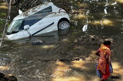 A damaged car lies in slush after being washed away during the recent floods on the outskirts of Srinagar on Monday | PTI
