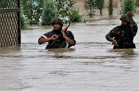 Indian army soldiers walk through a flooded road during a rescue operation in Srinagar, Thursday | AP
