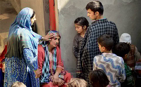 Family members of 24-years-old Zahid crying after the Kashmiri truck conductor who was injured in petrol bomb attack in Udhampur district dies in Delhi's Safdarjung Hospital at his residence in Batango in Anantnag District of South Kashmir on October 18.