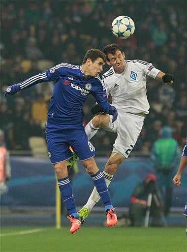 Chelsea's Oscar, left, and Dynamo's Danilo Silva go for the ball during the Champions League Group G soccer match between Dynamo Kiev and Chelsea FC in Kiev, Ukraine. | AP