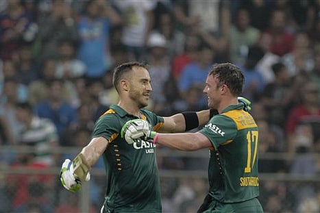South Africa’s Faf du Plessis, left, celebrates his hundred runs captain A.B. de Villiers during the final one-day international cricket match of a five-game series against India in Mumbai, India. |AP