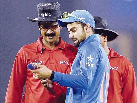 Virat Kohli shows a water bottle to the umpire which was thrown by crowd during T-20 match against South Africa in Cuttack on Monday l PTI
