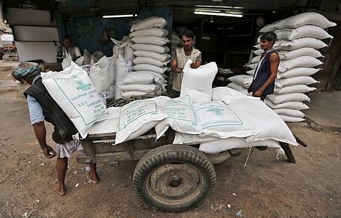Workers unload sacks containing sugar from a handcart at a wholesale market in Ahmedabad, August 5, 2015. | Reuters