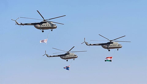 Indian Air Force helicopters fly past with Indian Tri Colour during the inauguration of the Aero India 2015 event at Yelhanka Air Base in Bengaluru. (PTI)