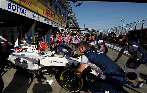 Finnish driver Valtteri Bottas' Williams is pushed back to his garage during the second practice session for the Australian Formula One Grand Prix at Albert Park in Melbourne, Australia, Friday | AP