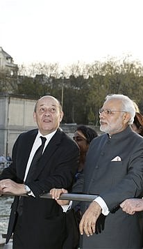 Indian Prime Minister Narendra Modi and French Defence Minister Jean-Yves Le Drian during an earlier tour on the Seine River, past the Eiffel Tower, during Modi's France visit.  File Photo | AP Photo