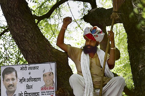 File photo of Gajendra Singh sitting in a tree during Aam Aadmi Party AAP 's rally against the Union government's Land Acquisition Bill at Jantar Mantar in New Delhi on April 22. (PTI)