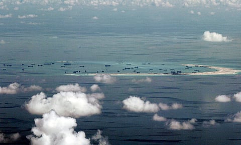 This areal photo taken through a glass window of a military plane shows China's alleged on-going reclamation of Mischief Reef in the Spratly Islands in the South China Sea Monday, May 11, 2015. Gen. Gregorio Pio Catapang, the Philippines' military chief