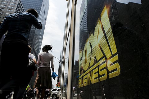 People pass near a poster of Fox at the Twenty-First Century Fox Inc headquarters in the Manhattan borough in New York. |Reuters