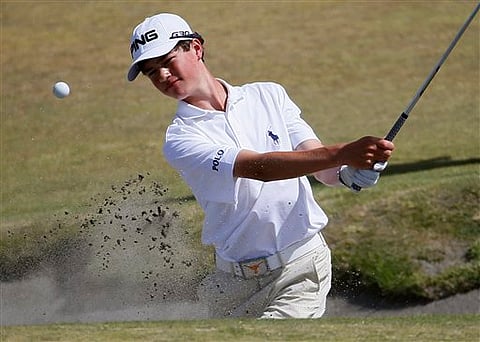 Cole Hammer, amateur, hits out of the bunker on the fifth hole during a practice round for the U.S. Open golf tournament at Chambers Bay. |AP