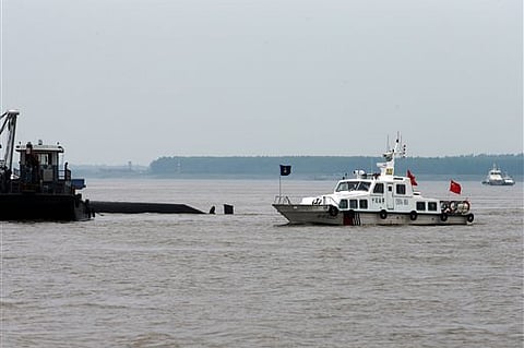 A marine boat patrols past the capsized ship on the Yangtze River in central China's Hubei province. |AP
