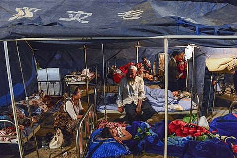 In this photo released by China's Xinhua News Agency, residents take a rest in tents following Friday's earthquake in Pishan county of Hotan prefecture, northwest China's Xinjiang Uygur Autonomous Region, Saturday, July 4, 2015. A magnitude 6.5 earthqu