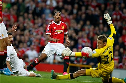 Manchester United's Anthony Martial scores past Liverpool's Simon Mignolet during the EPL match between Manchester United and Liverpool at Old Trafford.| AP