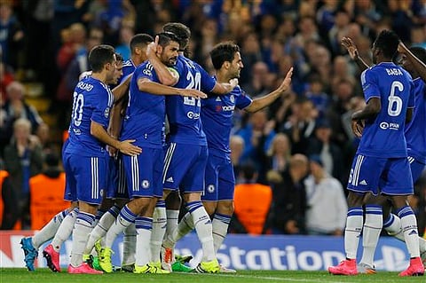 Chelsea players hug teammate Diego Costa, center left, after he scored 3-0 during the Champions League group G soccer match between Chelsea and Maccabi Tel Aviv at Stamford Bridge stadium in London. | AP Photo