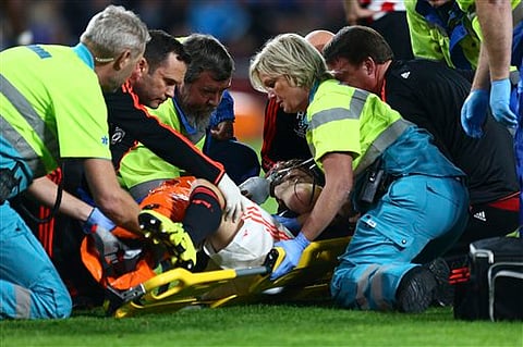 Medics prepare to carry Manchester United’s Luke Shaw off the pitch after being tackled by PSV's Hector Moreno, resulting in a double fracture of Shaw's right leg, during the Champions League Group B soccer match between PSV and Manchester United at Phi