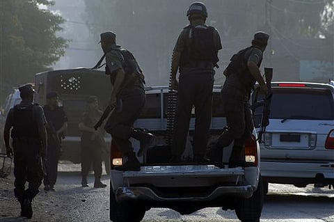 Pakistani commandos arrive at an air force base in Peshawar, Pakistan, Friday, Sept. 18, 2015. Militants in northwestern Pakistan attacked an air force base on the outskirts of Peshawar early Friday, triggering a shootout that left at least 20 wounded and