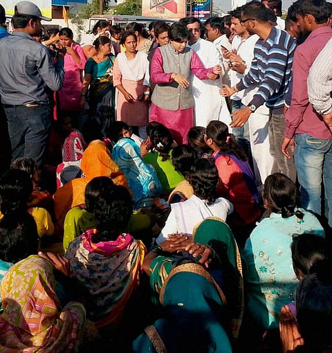Trupti Desai in pink who headed the protest by women activists for entry to the Shani Shignapur temple complex participate in dharna at the temple in Ahmadnagar district on Tuesday. | PTI