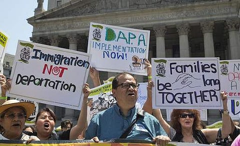 Demonstrators protest against a Supreme Court decision on immigration outside the New York Supreme court. | AP