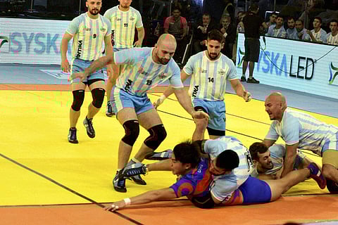 A Korean player touches the center line as Argentina players fail to stop during their ''Kabaddi World Cup 2016'' match in Ahmedabad on Sunday. | PTI