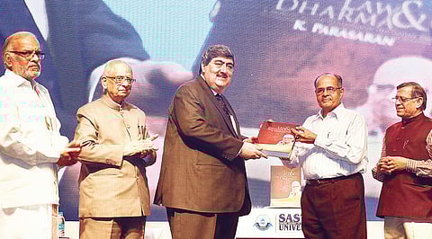 Chief Justice of the Madras High Court Sanjay Kishan Kaul presenting the first copy of ‘Law & Dharma’ to Prof N R Madhava Menon, Chancellor of Central University of Chhattisgarh, in the city on Sunday