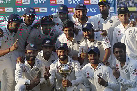 The Indian cricket team poses for photographs with the ICC Test Championship mace at the end of their third test cricket match against New Zealand in Indore, India. | AP