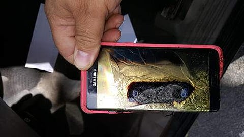 A parent shows the replacement Samsung Galaxy Note 7 phone belonging to his 13-year-old daughter Abby, that melted in her hands. |AP