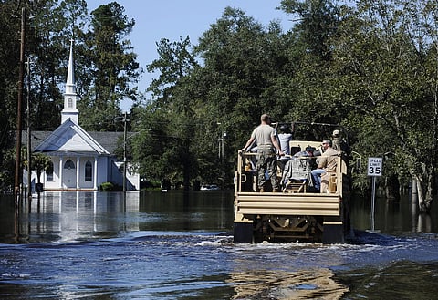 A National Guard high-water vehicle drives through Nichols | AP