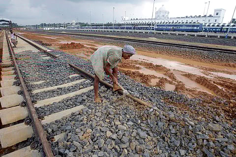 A labourer works at the installation site of a new railway track on the outskirts of Agartala, India, October 13, 2016. | Reuters