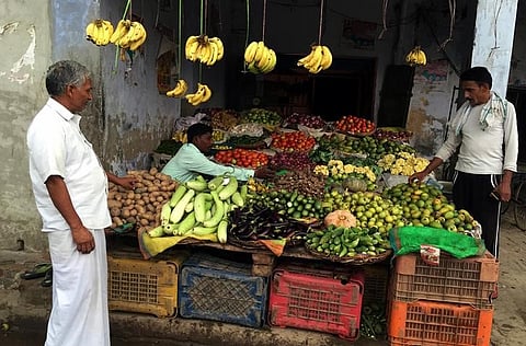 A villager buys vegetables at a shop in the village of Sisauli in Uttar Pradesh, India, July 8, 2016. | Reuters