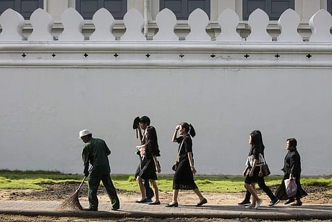 Thais walk in line as they head for a bathing ceremony for deceased Thai King Bhumibol Adulyadej outside the Grand Palace in Bangkok, Thailand on October 14th. (Photo | AP)