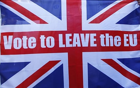 A Vote Leave supporter holds up a Union flag outside Downing Street after Britain voted to leave on the European Union in London, Britain.| Reuters