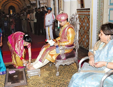Trishika Kumari performing padapuja to Yaduveer Krishnadatta Chamaraja Wadiyar at Amba Vilas Palace in  Mysuru on Saturday | Express