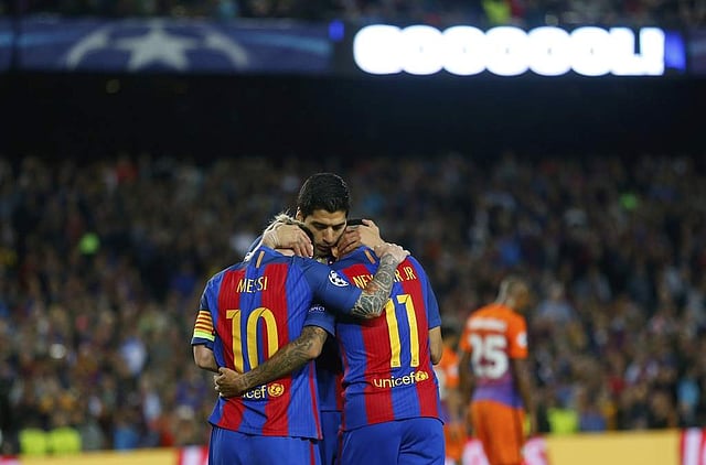 Barcelona's Lionel Messi, Luis Suarez and Neymar, celebrate their fourth goal during a Champions League Group C soccer match between Barcelona and Manchester City at Camp Nou. 