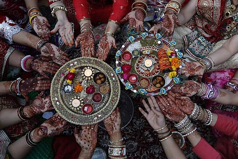 Married women decorate their hands with henna on Karva Chauth festival and observe a fast to pray for the longevity and well being of their husbands. (Photo | AP)