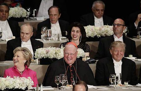 Cardinal Timothy Dolan, center, Democratic presidential candidate Hillary Clinton, left, Republican presidential nominee Donald Trump, right, smile during the annual Al Dinner. (File photo | AP)