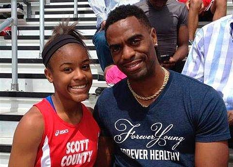 In this file photo, Trinity Gay, a seventh-grader racing for her Scott County High School team, poses for a photo with her father Tyson Gay. | AP