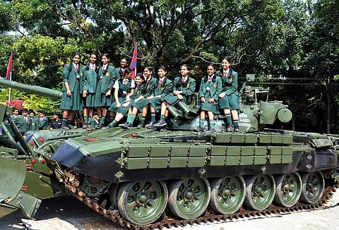 School children enjoy sitting on top of a tank displayed at the Ceremonial Parade consisting of six contingents and massive engineer equipment at the Madras Engineer Centre in Bengaluru. (Photo | EPS)