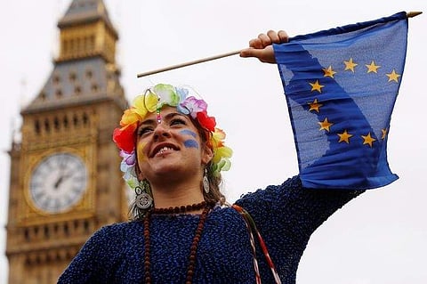 A Pro-Europe demonstrator waves a flag during a 'March for Europe' protest against the Brexit vote result earlier in the year, in London | Reuters