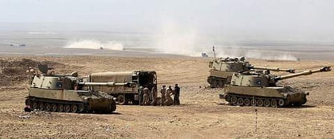 Iraqi forces fire artillery shells towards Zalhafa village from their position on the outskirts of the village of al-Khuwayn, south of Mosul, after recapturing it from Islamic State (IS). (Photo| AFP)