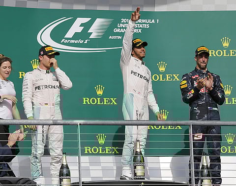 The winner takes it all: Lewis Hamilton in the center. (Photo | AP)