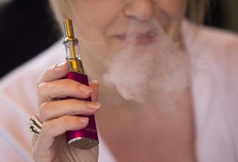A woman smokes an electronic cigarette in London. (Photo | Reuters)