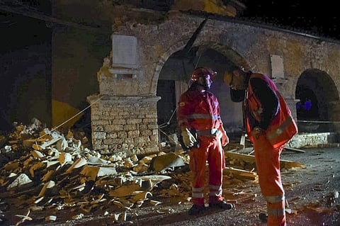 Rescuers stand by rubble in the village of Visso, central Italy, Wednesday, Oct. 26, 2016 following an earthquake. | AP