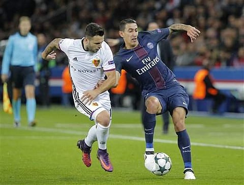 PSG's Angel Di Maria, right, challenges for the ball with Basel's Renato Steffen during the Champions League group A soccer match. | AP