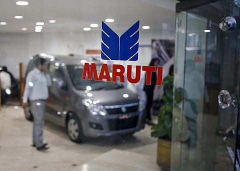 The logo of Maruti Suzuki India Limited is seen on a glass door at a showroom in New Delhi | Reuters